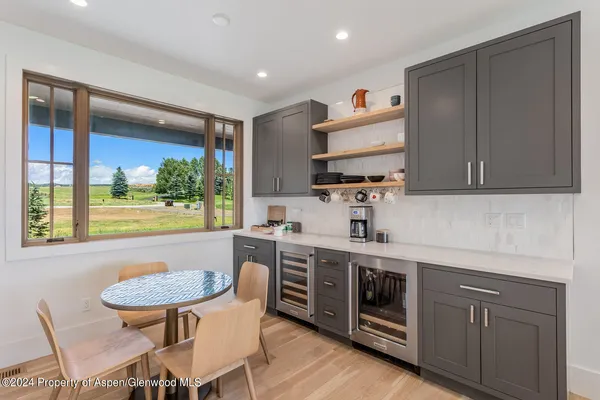 a living room with stainless steel appliances kitchen island granite countertop a stove and a sink