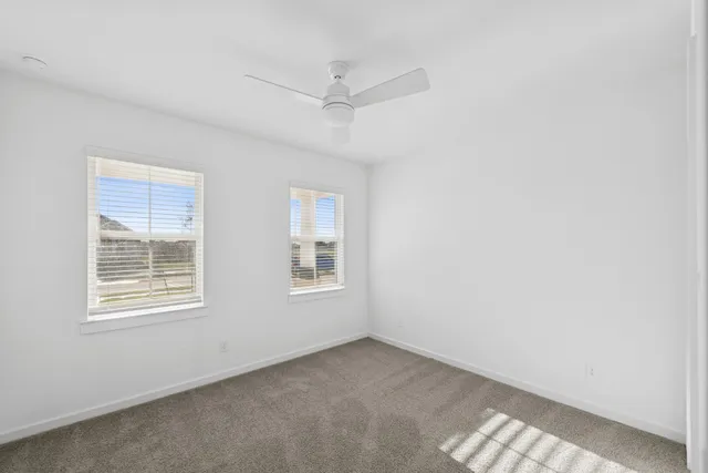 a large white kitchen with lots of counter space wooden floor and appliances
