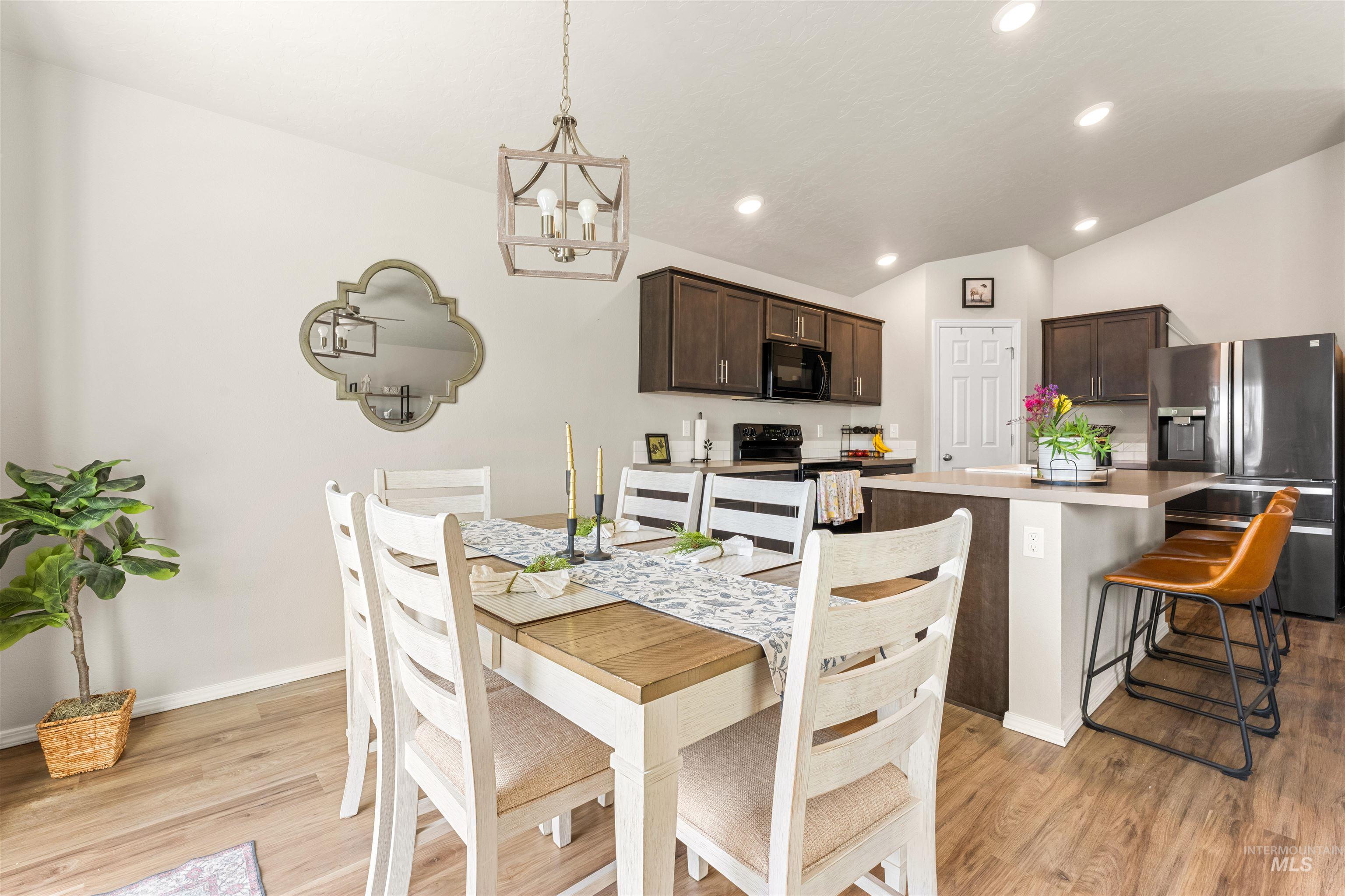16378 Kelso Way Caldwell, ID 83607 - Photo 17 of 34 Dining room featuring light wood-type flooring, vaulted ceiling, and recessed lighting