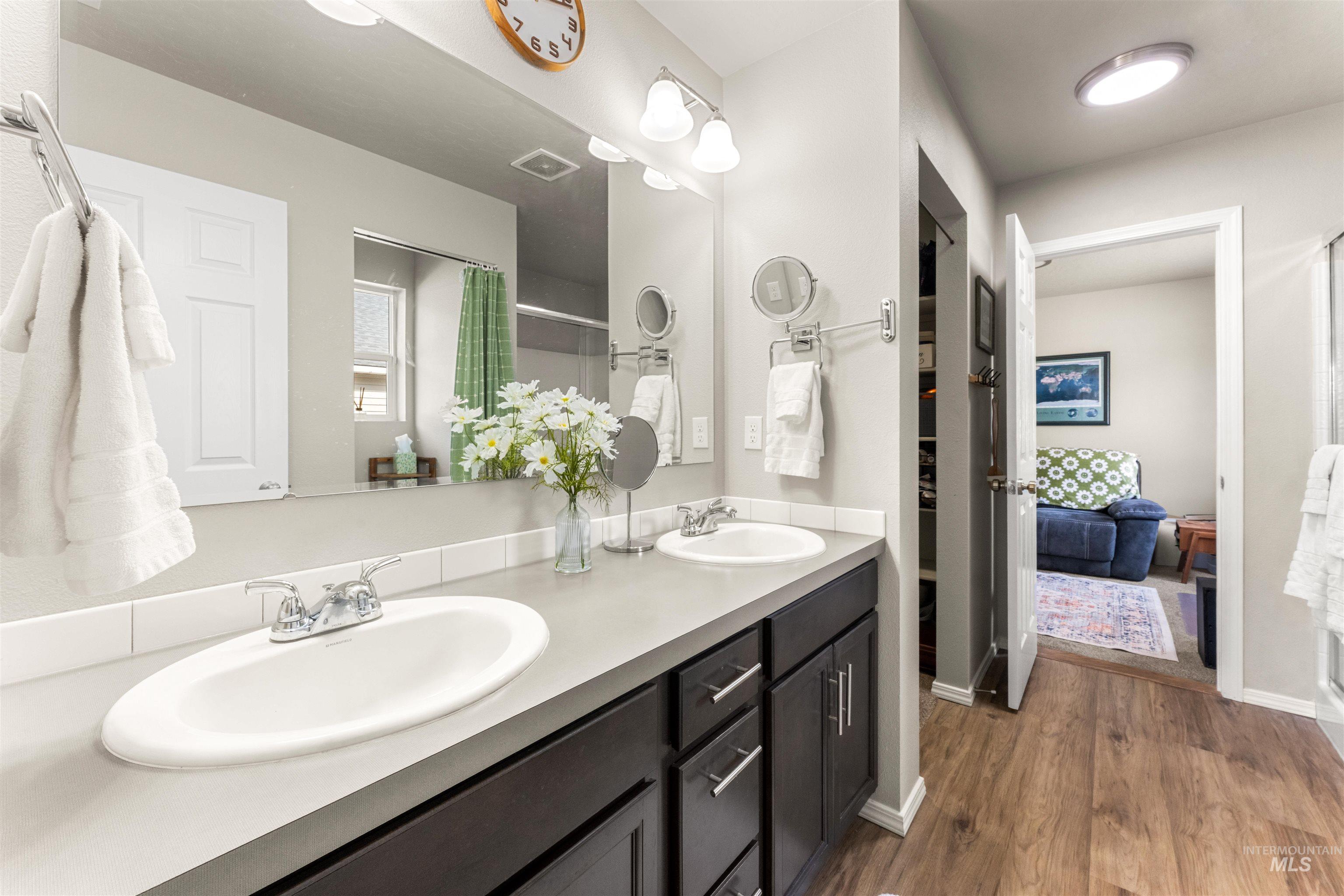 16378 Kelso Way Caldwell, ID 83607 - Photo 22 of 34 Full bath with double vanity, dark wood-type flooring, and a shower with shower curtain