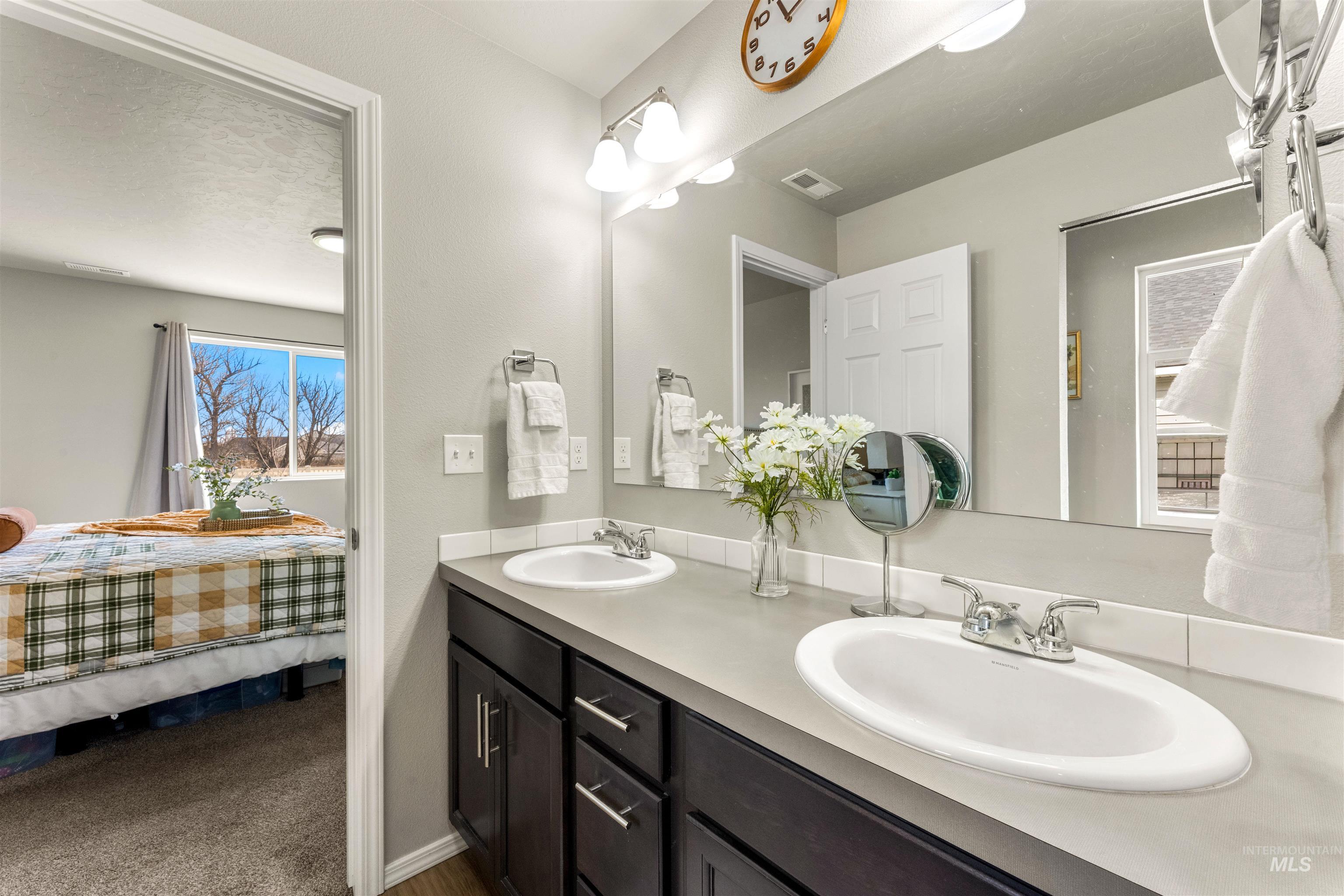16378 Kelso Way Caldwell, ID 83607 - Photo 23 of 34 Bathroom with ensuite bath, double vanity, and dark colored carpet