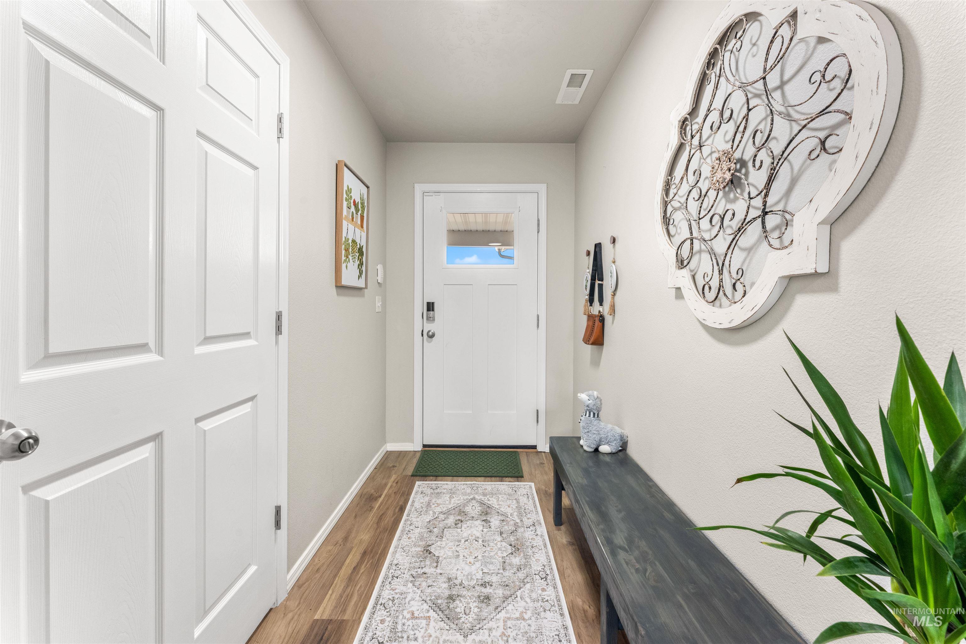 16378 Kelso Way Caldwell, ID 83607 - Photo 10 of 34 Doorway with wood finished floors and baseboards