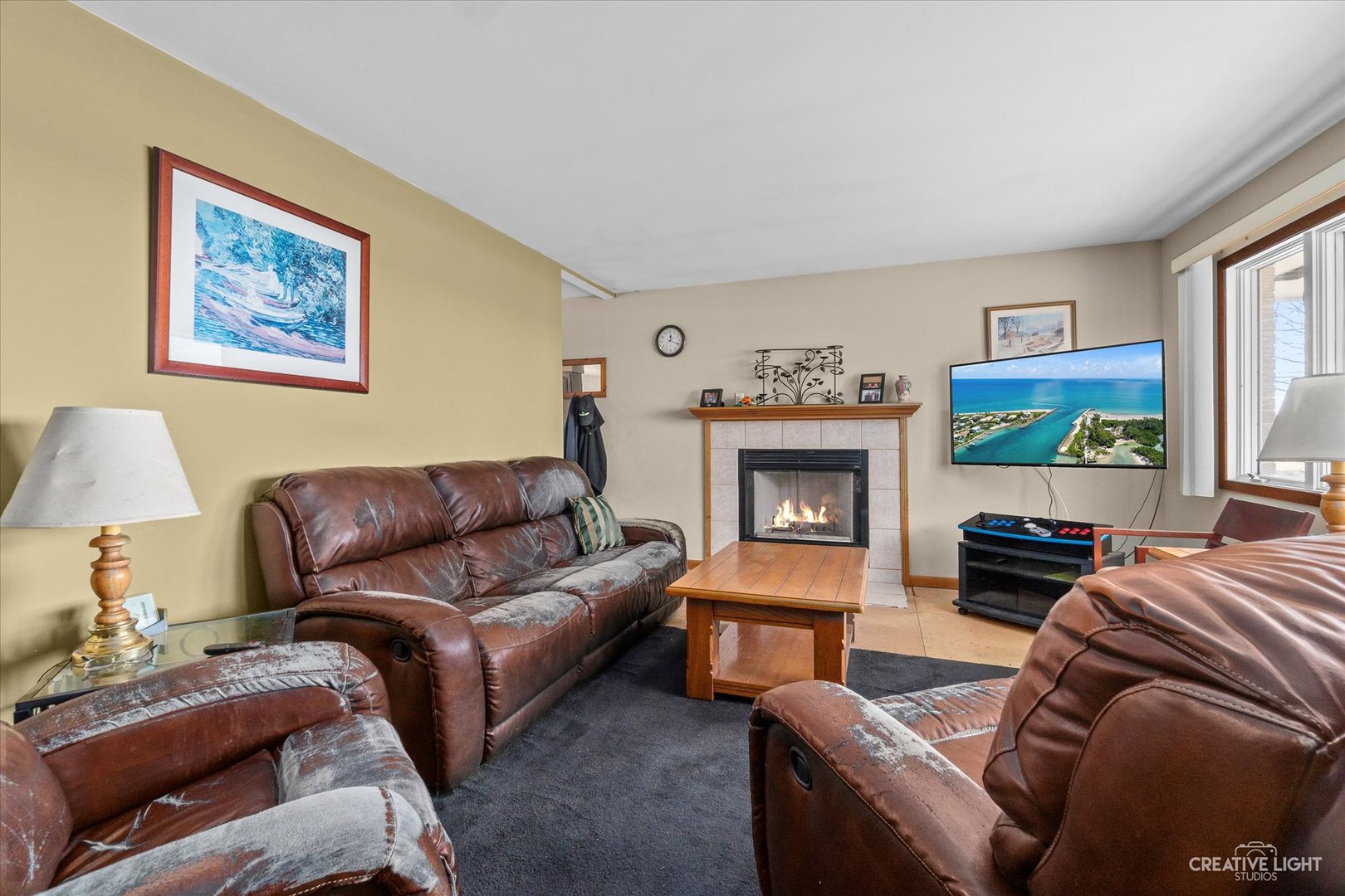 9956 Rimsnider Road Hinckley, IL 60520 - Photo 3 of 22 a living room with furniture a fireplace and a window
