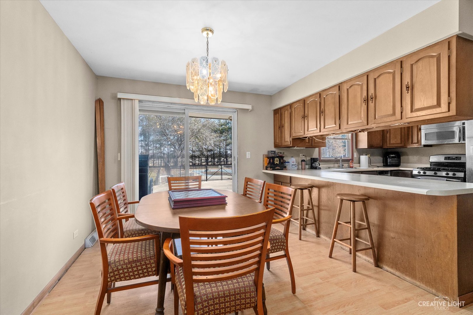 9956 Rimsnider Road Hinckley, IL 60520 - Photo 5 of 22 a view of a dining room with furniture a chandelier and wooden floor