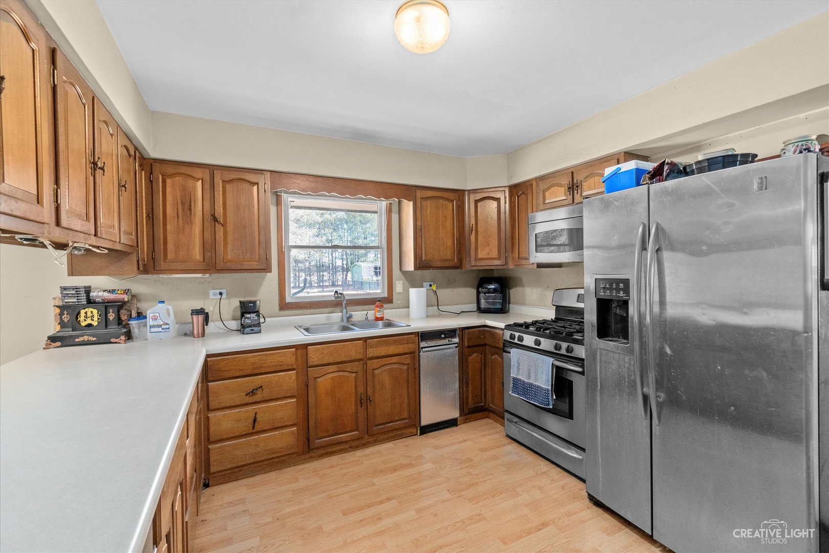 9956 Rimsnider Road Hinckley, IL 60520 - Photo 6 of 22 a kitchen with stainless steel appliances granite countertop a stove top oven a sink and dishwasher