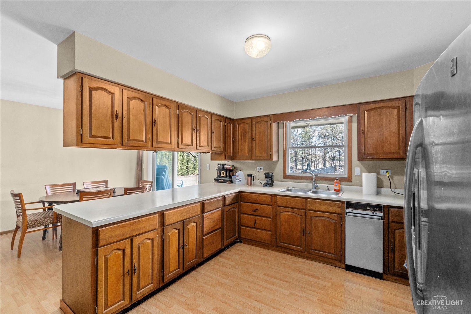 9956 Rimsnider Road Hinckley, IL 60520 - Photo 7 of 22 a kitchen with stainless steel appliances granite countertop a sink stove and refrigerator