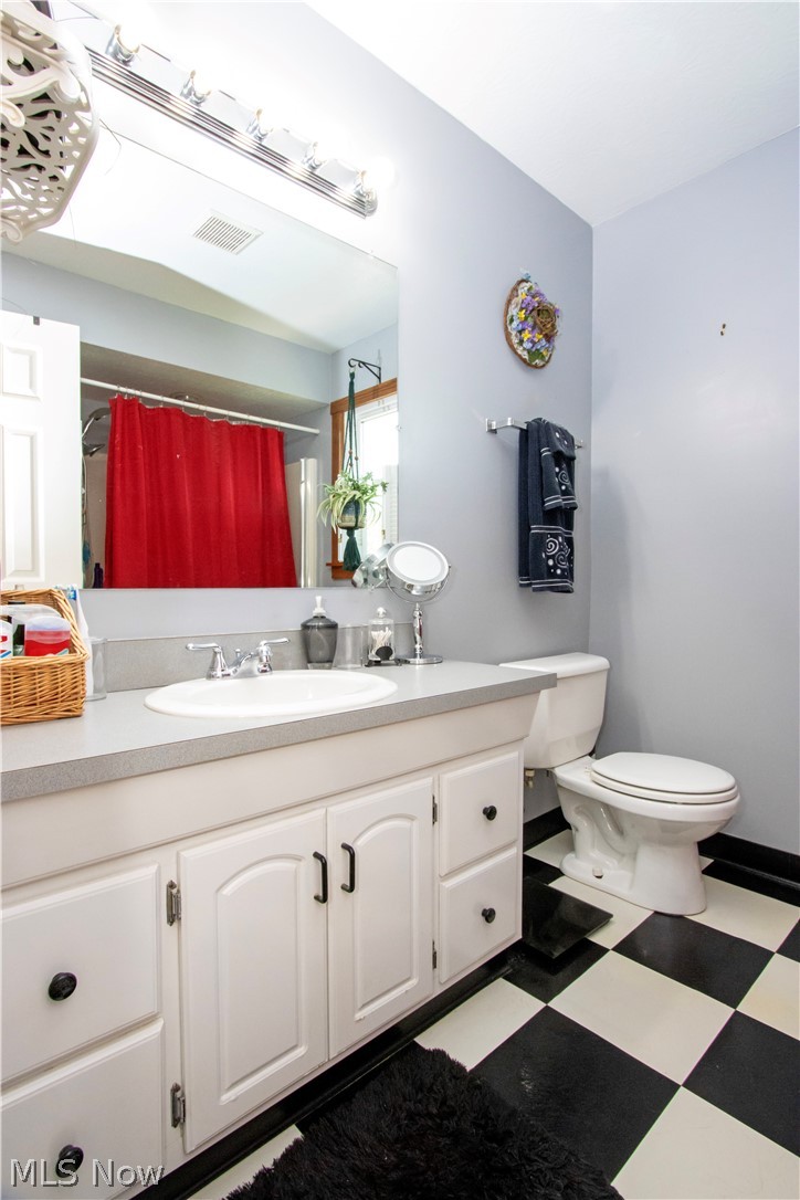 1043 North Honeytown Road Wooster, OH 44691 - Photo 17 of 46 Bathroom featuring a white vanity with black hardware, a light gray countertop, and a white oval sink