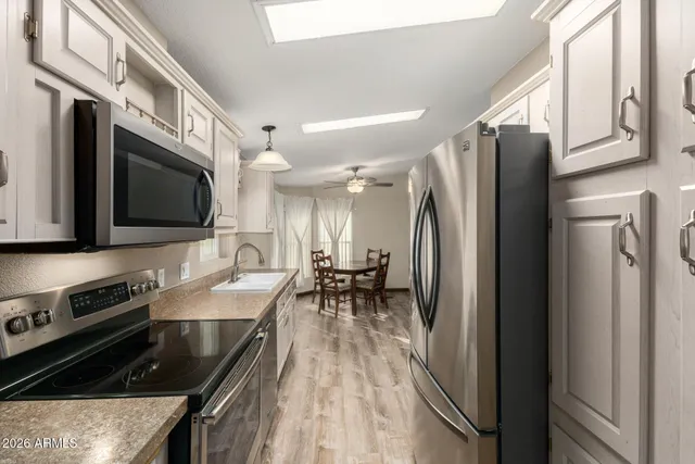 a kitchen with stainless steel appliances granite countertop a refrigerator stove and microwave