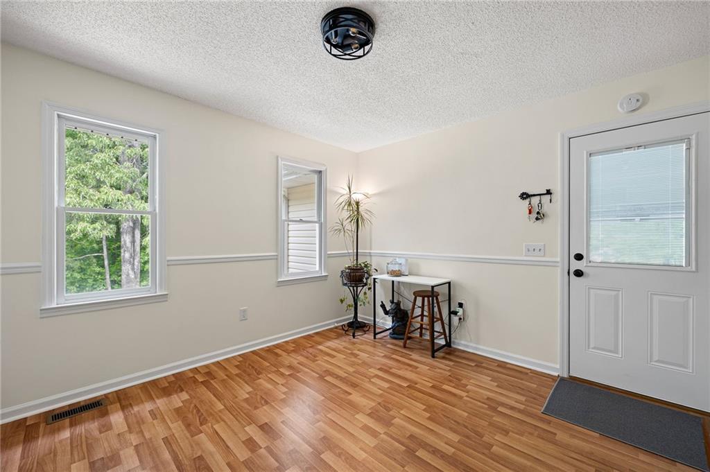 687 Cotton Road Canton, GA 30115 - Photo 17 of 38 wooden floor in an empty room with a window