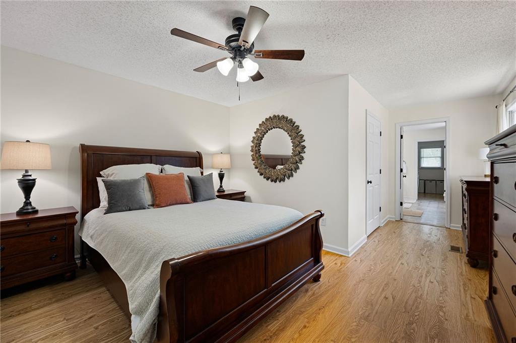 687 Cotton Road Canton, GA 30115 - Photo 19 of 38 a bed room with a bed and a chandelier