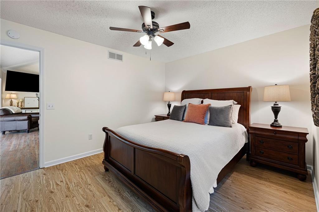687 Cotton Road Canton, GA 30115 - Photo 20 of 38 a bedroom with a bed and a flat tv screen on dresser