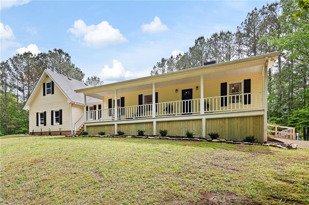 687 Cotton Road Canton, GA 30115 - Photo 2 of 38 a front view of a house with a garden