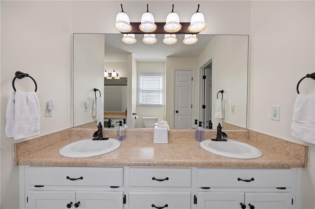 687 Cotton Road Canton, GA 30115 - Photo 23 of 38 a bathroom with a sink double vanity and a mirror