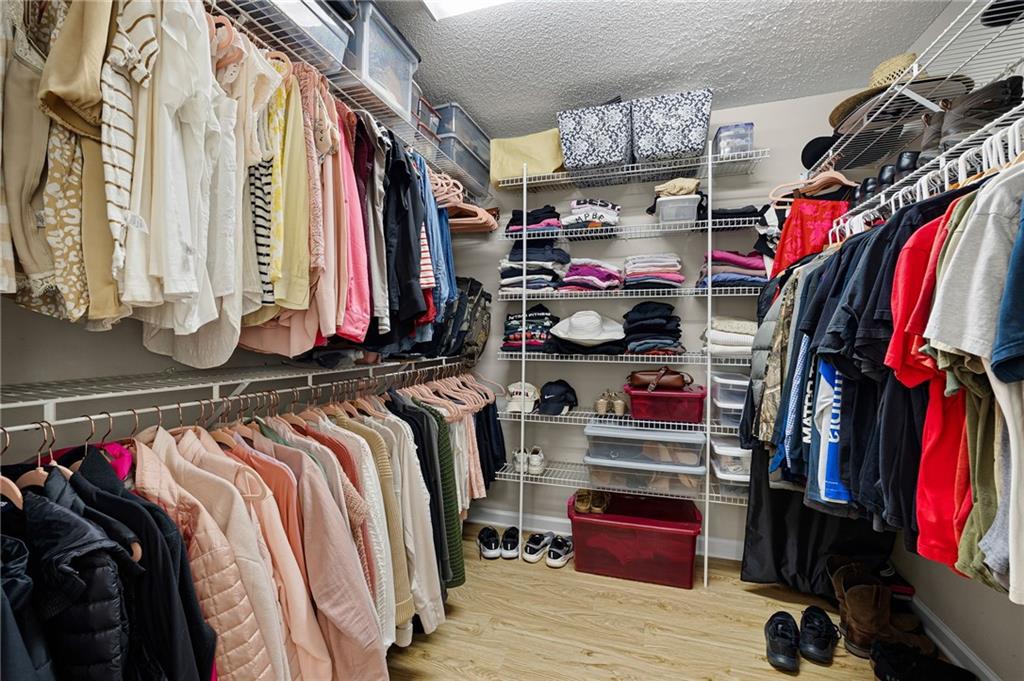 687 Cotton Road Canton, GA 30115 - Photo 24 of 38 a view of walk in closet with clothes and shoes