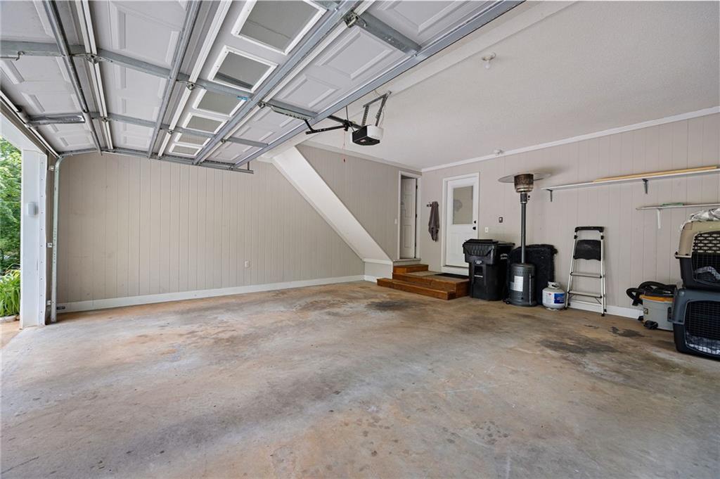 687 Cotton Road Canton, GA 30115 - Photo 32 of 38 a view of a livingroom with furniture and a garage