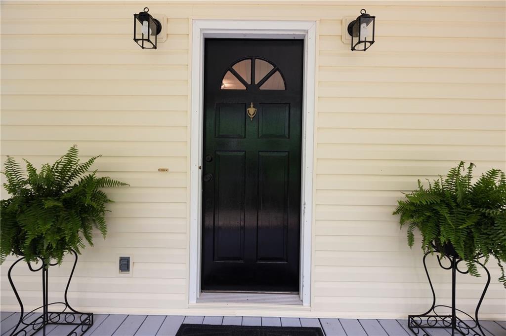 687 Cotton Road Canton, GA 30115 - Photo 5 of 38 a potted plant on the wooden door of a house