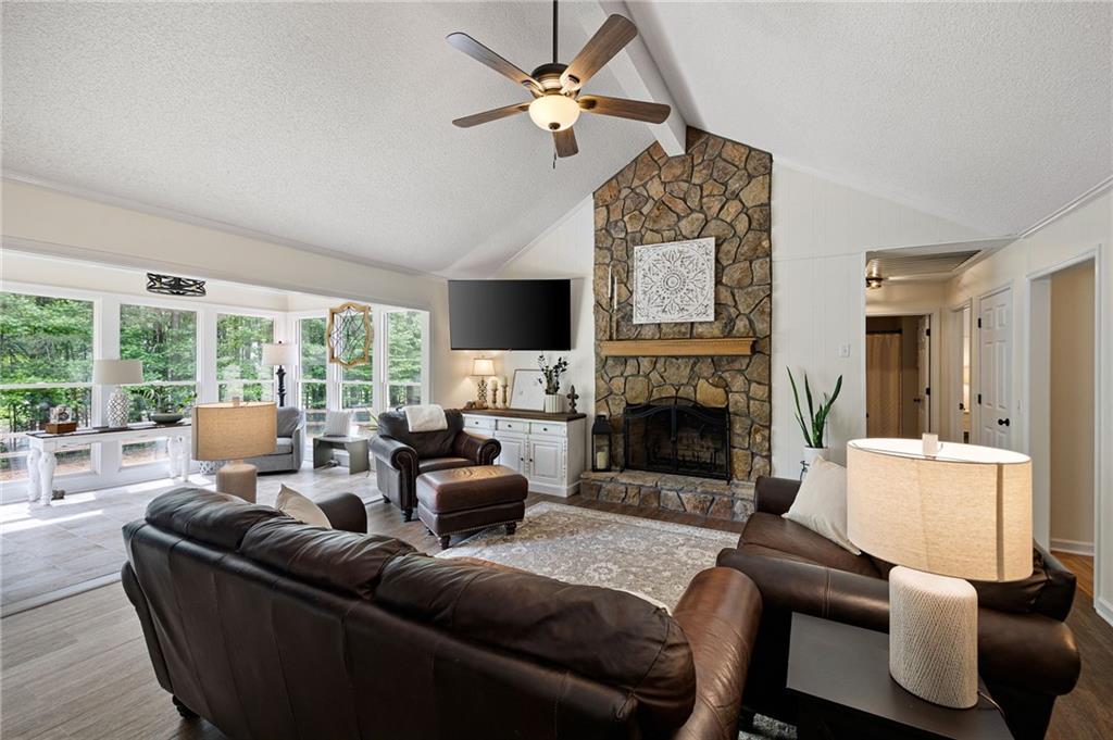 687 Cotton Road Canton, GA 30115 - Photo 7 of 38 a living room with furniture a fireplace and a large window
