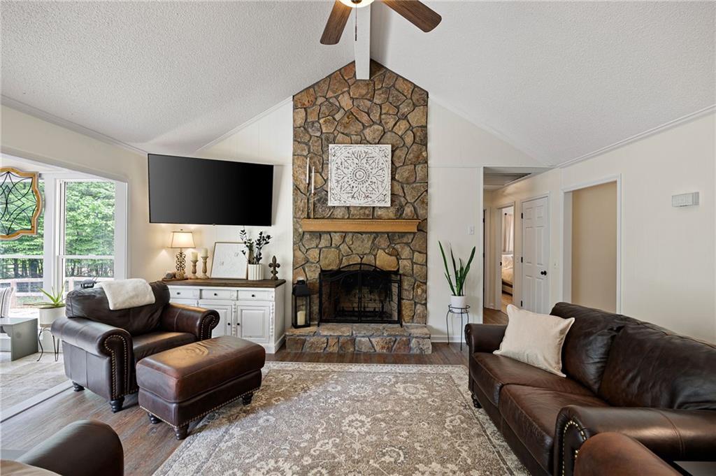 687 Cotton Road Canton, GA 30115 - Photo 8 of 38 a living room with furniture a flat screen tv and a fireplace