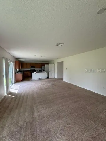 a view of empty room with furniture and storage