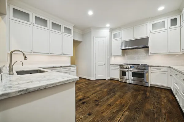 a kitchen with stainless steel appliances granite countertop a stove and a sink