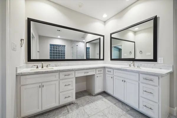 a bathroom with a double vanity sink and a mirror