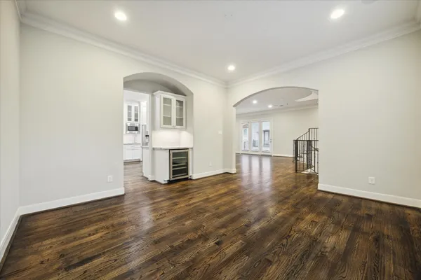 a view of a room with wooden floor and kitchen