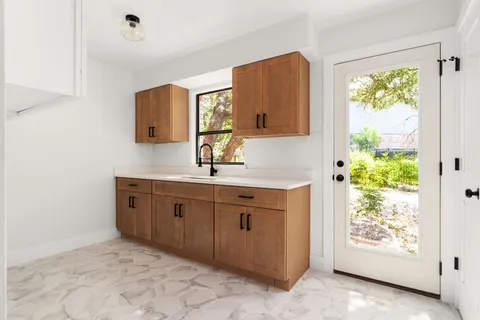 a spacious bathroom with a granite countertop sink and a mirror