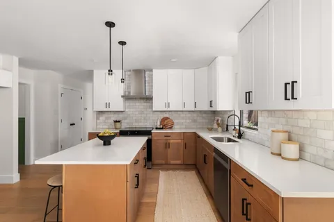 a kitchen with a sink a stove and cabinets