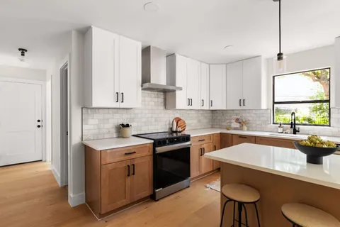 a kitchen with a sink stove and cabinets