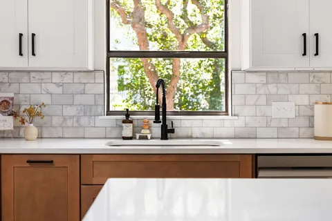 a kitchen with granite countertop a sink and a window