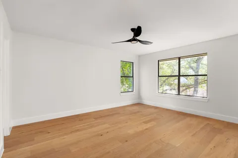 a view of a yard with wooden fence
