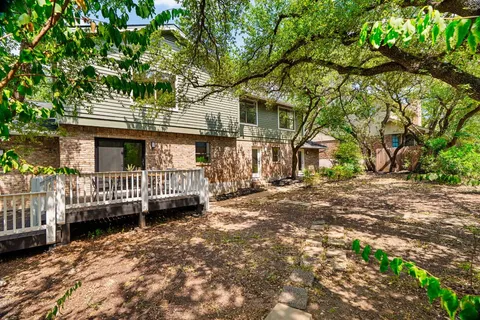a view of a patio with table and chairs with wooden floor and fence