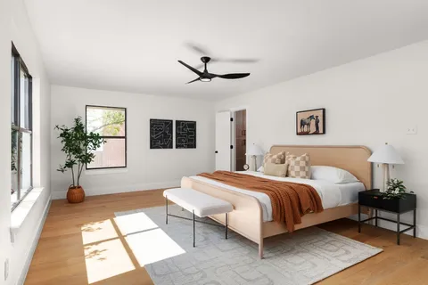 a spacious bedroom with a large bed and a window