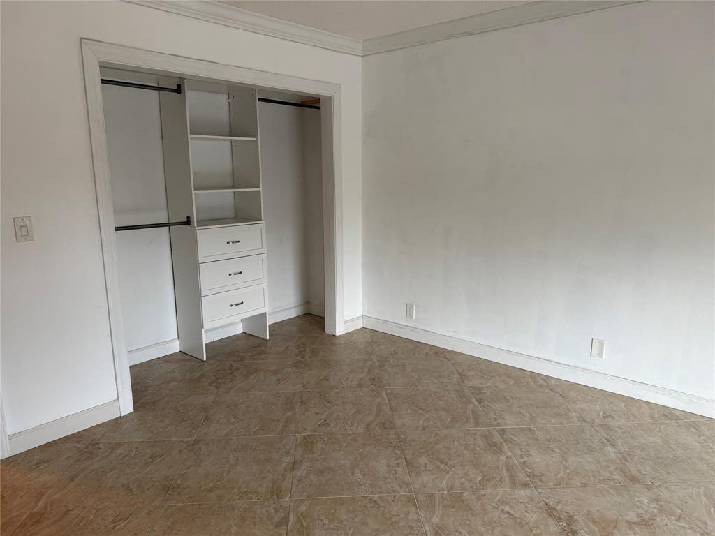 2131 Northeast 42nd Court, Unit 202E Lighthouse Point, FL 33064 - Photo 11 of 22 wooden floor and cabinet in a room