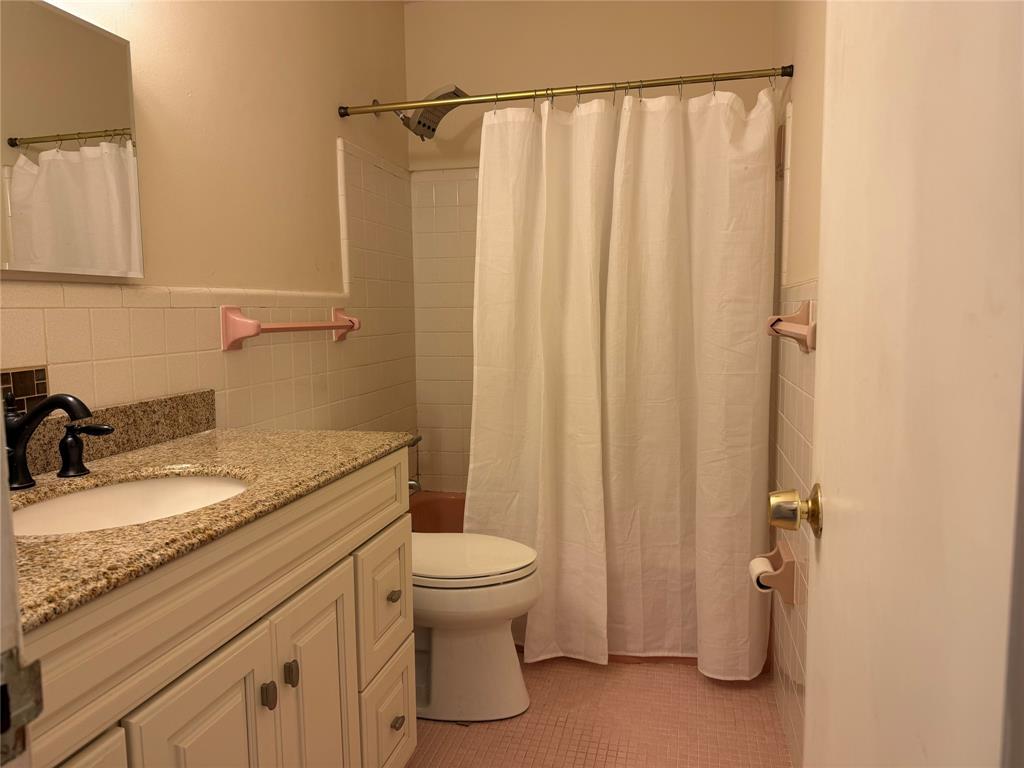 2131 Northeast 42nd Court, Unit 202E Lighthouse Point, FL 33064 - Photo 14 of 22 a bathroom with a granite countertop sink toilet and shower
