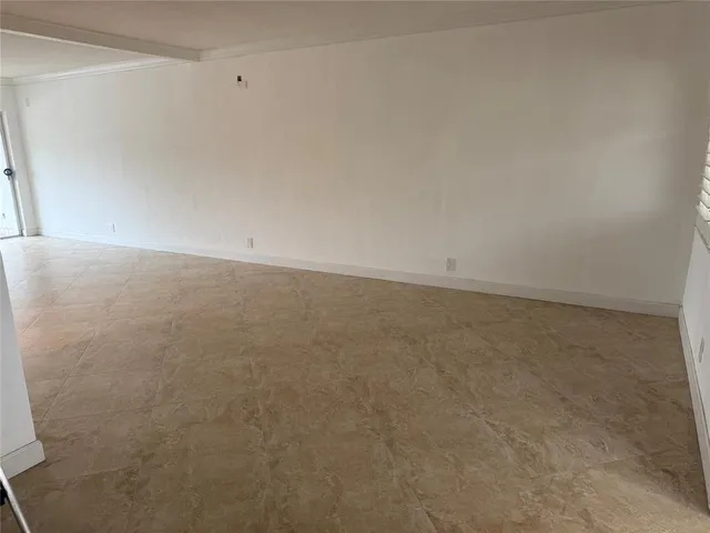 a view of an empty room and wooden floor