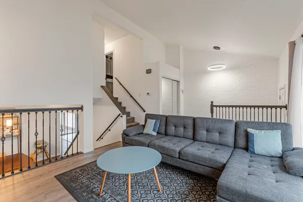 a living room with furniture and a rug