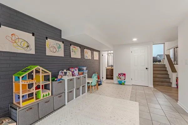 a living room with lots of furniture and toys