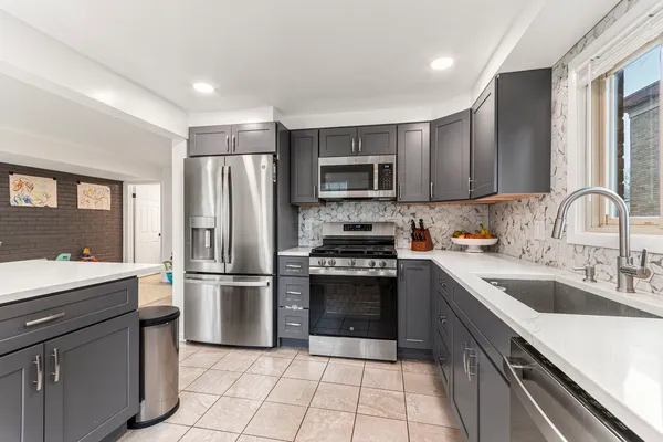 a kitchen with a sink cabinets and stainless steel appliances