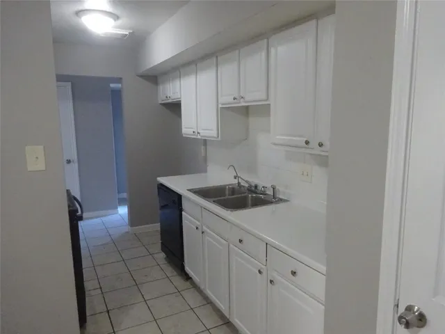 a kitchen with a sink and cabinets