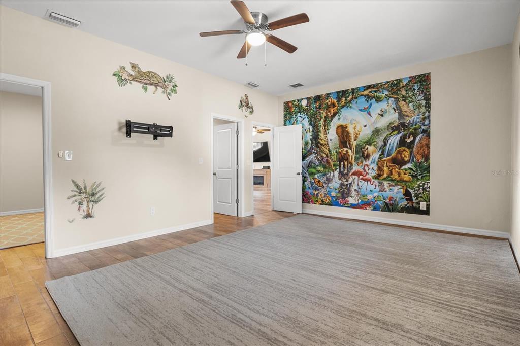4020 Connersville Road Bartow, FL 33830 - Photo 18 of 50 a view of a hallway with wooden floor and a ceiling fan