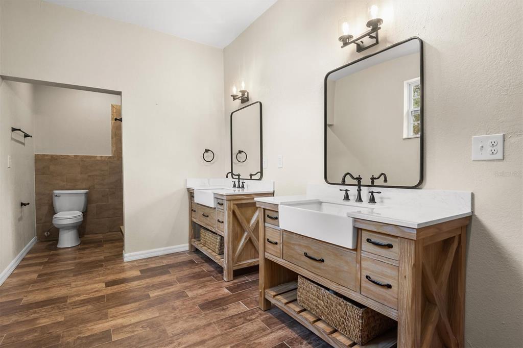 4020 Connersville Road Bartow, FL 33830 - Photo 22 of 50 a bathroom with a double vanity sink mirror and toilet