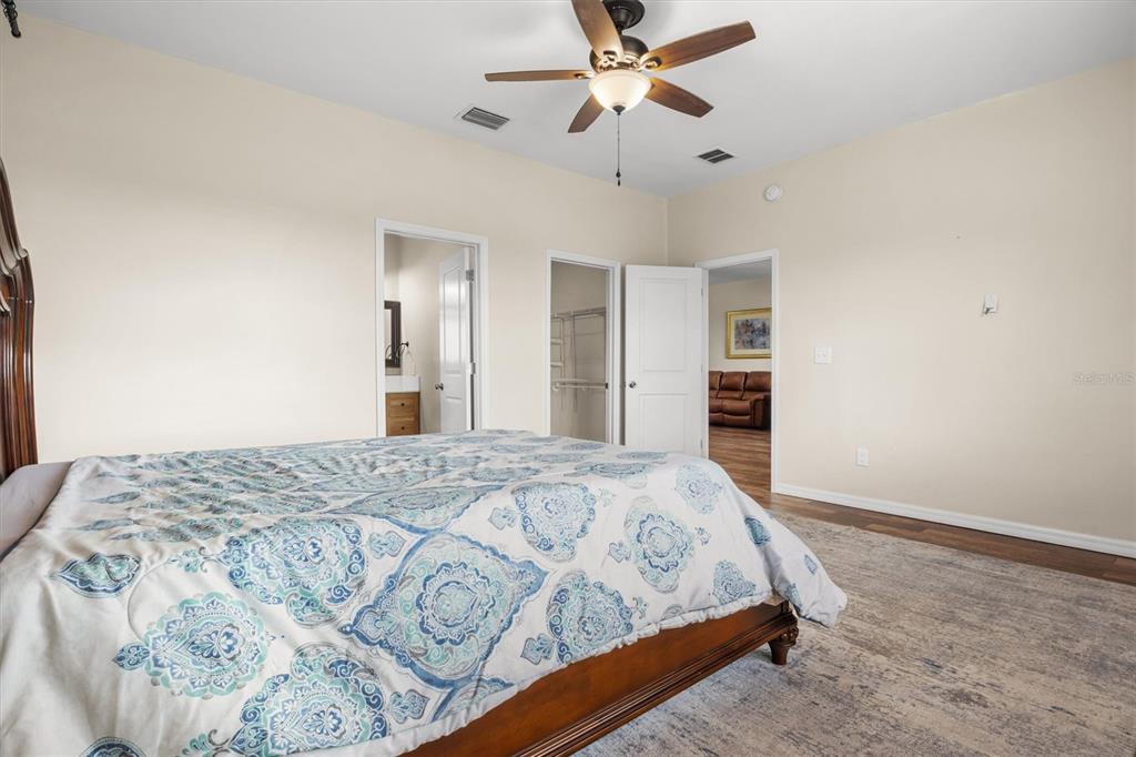 4020 Connersville Road Bartow, FL 33830 - Photo 26 of 50 a bedroom with a bed and a chandelier