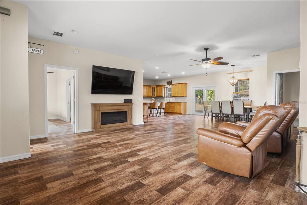 4020 Connersville Road Bartow, FL 33830 - Photo 4 of 50 a living room with furniture a flat screen tv and a fireplace