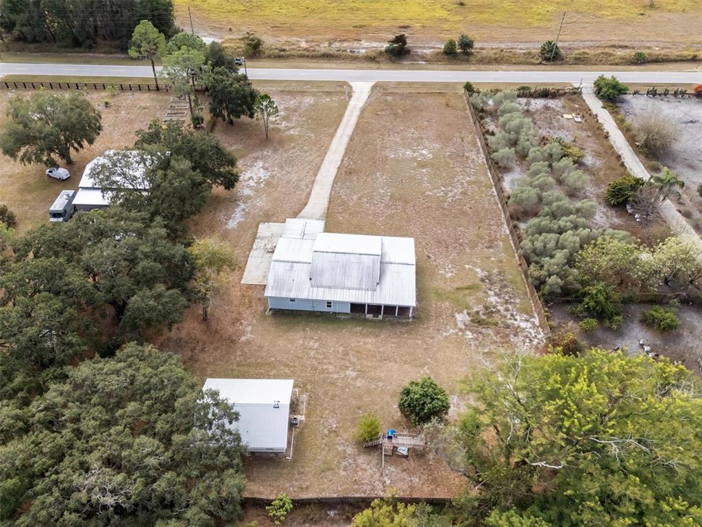 4020 Connersville Road Bartow, FL 33830 - Photo 50 of 50 an aerial view of a house with a yard and lake view