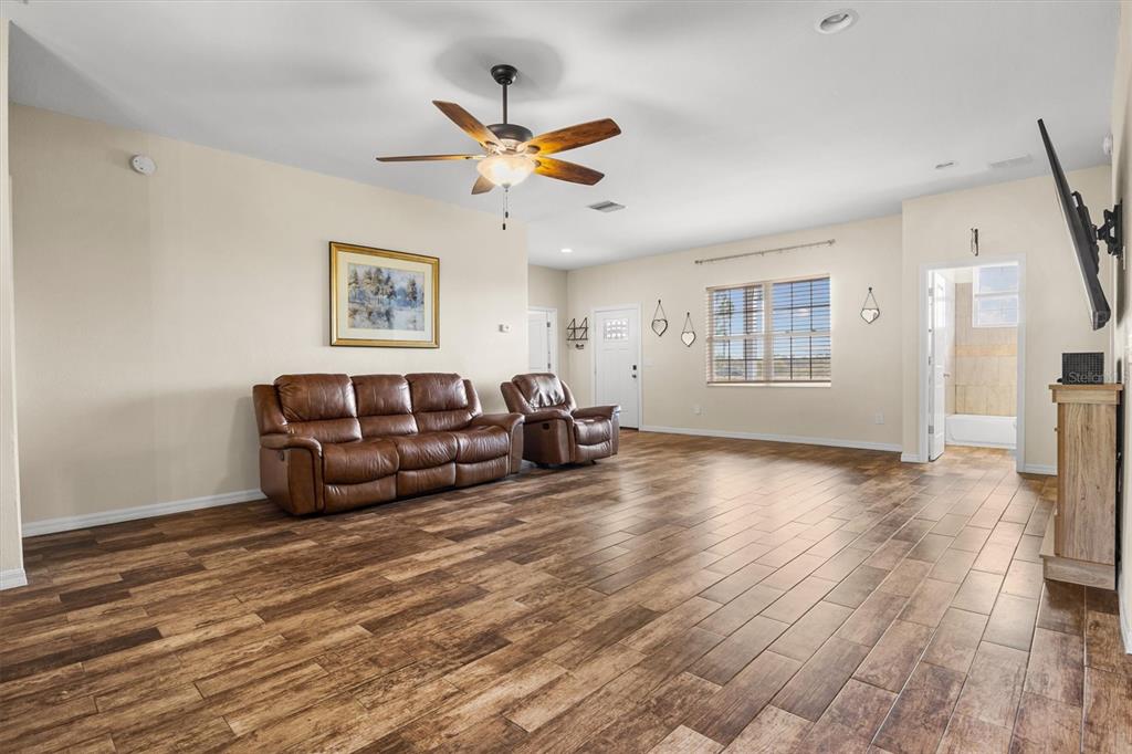 4020 Connersville Road Bartow, FL 33830 - Photo 5 of 50 a living room with couches and painting on the wall with wooden floor