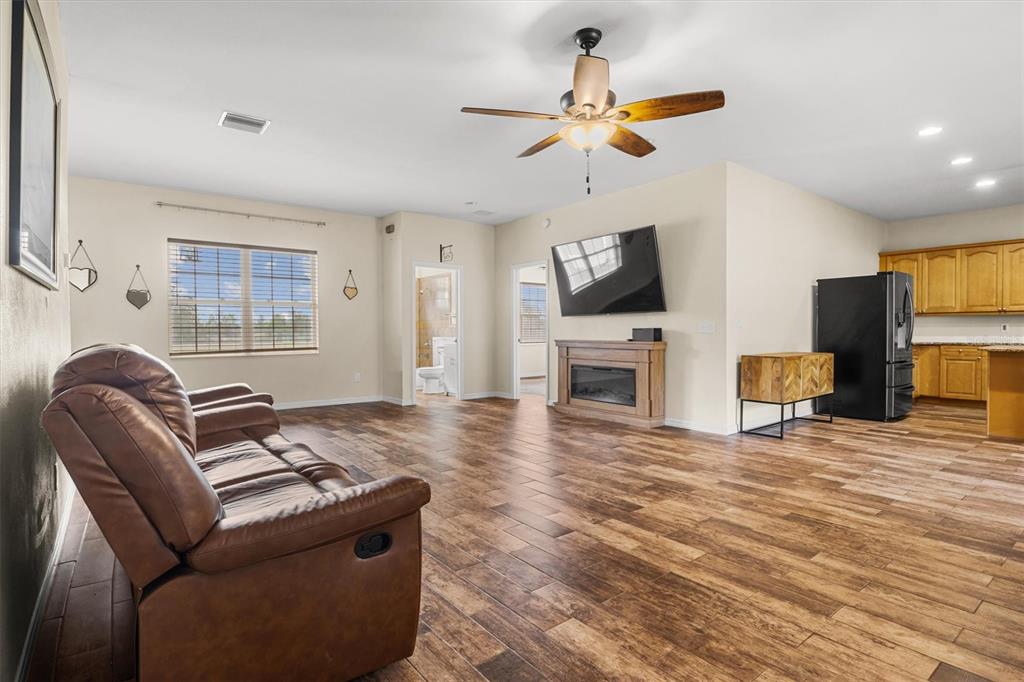 4020 Connersville Road Bartow, FL 33830 - Photo 6 of 50 a living room with furniture a fireplace and a flat screen tv