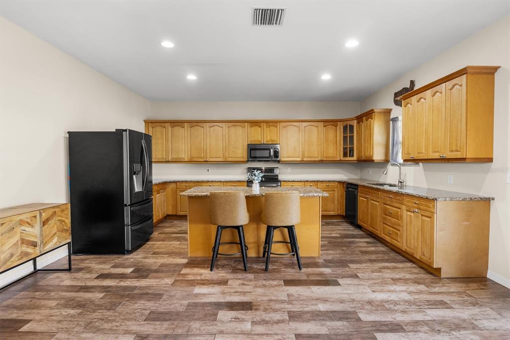 4020 Connersville Road Bartow, FL 33830 - Photo 10 of 50 a kitchen with stainless steel appliances granite countertop a refrigerator a stove top oven and a sink with granite countertops