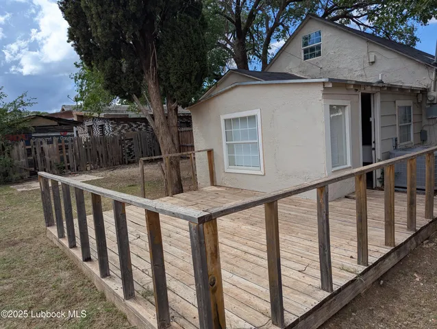 a view of a house with wooden fence