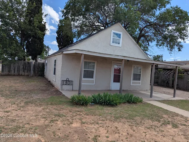 a front view of house with a yard and trees